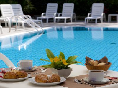 Colazione a bordo piscina con croissant e caffè.